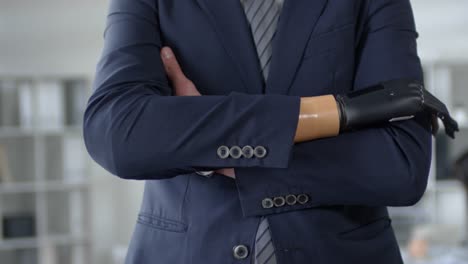 Businessman-with-Prosthetic-Bionic-Hand-Standing-with-Arms-Crossed