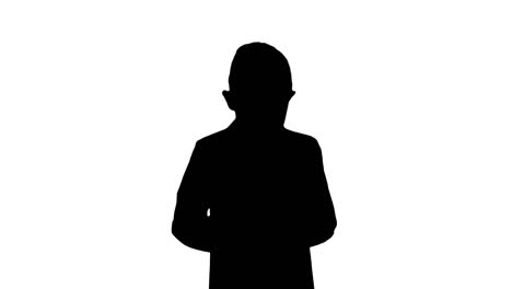 Silhouette-Small-boy-in-costume-walking-and-using-smartphone