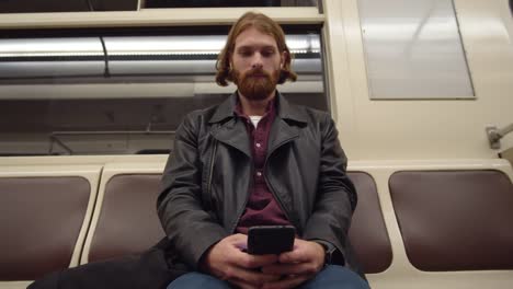 Man-Sitting-in-Subway-Car