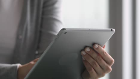 Close-up-view-of-businesswoman-holding-using-digital-tablet-concept