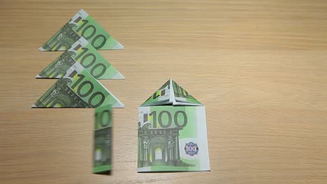 Geld-Baum-Haus-Symbol-Holztisch-Hintergrund