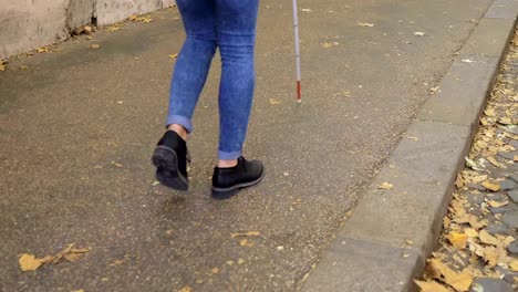 close-up-on-Blind-person-walking-on-sidewalk-with-stick.Handicap,-autonomy,-independence