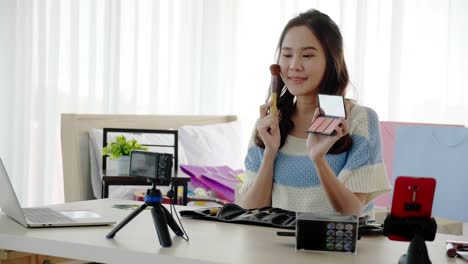 Asian-women-beautiful-bloggers-wear-colourful-clothes-Such-as-green,-pink-Standing-and-dancing-in-headphones.-Communicate-sales-to-customers-via-live-video.-Online-selling-business-via-social-media