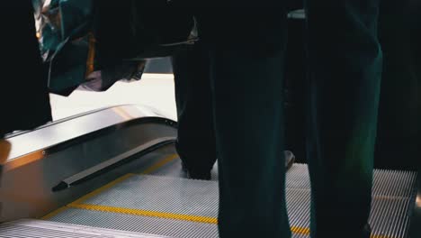 Legs-of-People-Moving-on-an-Escalator-Lift-in-the-Mall.-Shopper's-Feet-on-Escalator-in-Shopping-Center