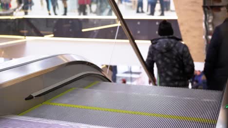 Legs-of-People-Moving-on-an-Escalator-Lift-in-the-Mall.-Shopper's-Feet-on-Escalator-in-Shopping-Center