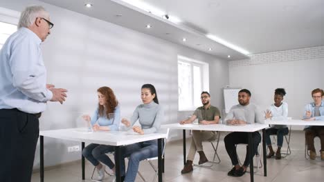 Estudiantes-que-trabajan-en-tabletas-de-realidad-aumentada-con-pantalla-táctil-en-clase-y-responden-preguntas