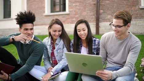 Mixed-race-students-look-through-the-laptop-watching-on-screen-information-online