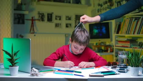 The-child-does-assignments-at-a-table-in-school.