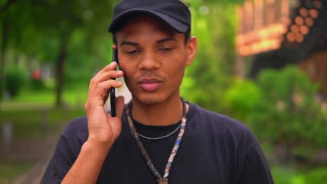 handsome-man-talking-by-mobile-on-the-run-outdoors