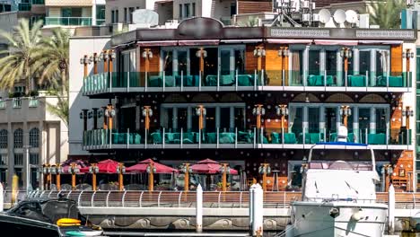 Paseo-marítimo-y-de-los-restaurantes-timelapse-en-la-Marina-a-pie-durante-el-día.-Dubai,-Emiratos-Árabes-Unidos