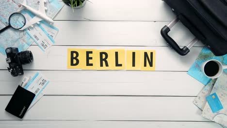 Top-view-time-lapse-hands-laying-on-white-desk-word-""-decorated-with-travel