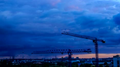 Work-of-construction-cranes-at-sunset