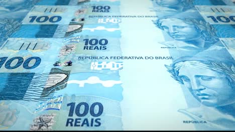 Series-of-banknotes-of-one-hundred-brazilian-reals-of-the-bank-of-Brazil-rolling-on-screen,-coins-of-the-world,-cash-money,-loop