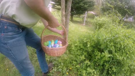 Man-hiding-an-Easter-egg-for-a-traditional-Easter-egg-hunt