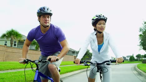 Asian-Chinese-male-female-couple-cycling-outdoors-together