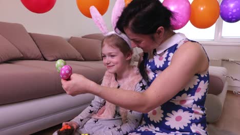 Mother-showing-for-daughter-decorative-Easter-eggs