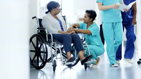 Multi-ethnic-team-and-senior-patient-in-wheelchair