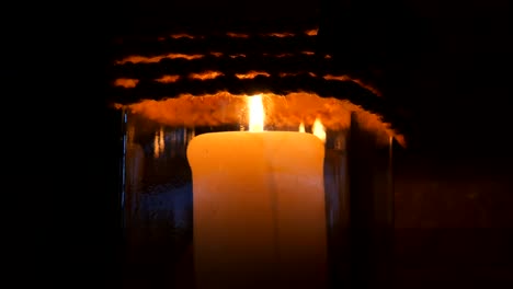 Candle-in-a-restaurant-on-a-black-background-in-a-candlestick.