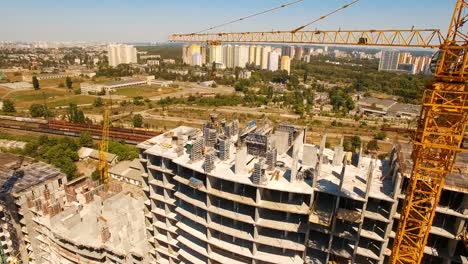 Aerial-shot-of-workers-in-a-construction,-structure-in-the-process-to-be-build