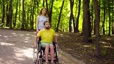 Young-disable-man-on-a-walk-in-the-park-with-his-wife