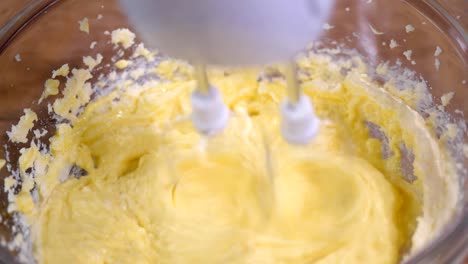 Adding-eggs-to-dough.-Making-cake-in-the-kitchen.