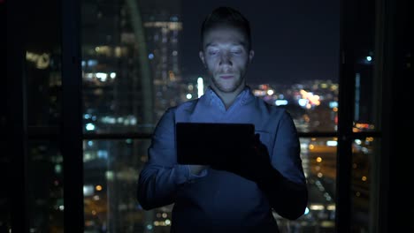 Caucasian-man-using-digital-tablet-for-internet-and-communications-with-cityscape-background