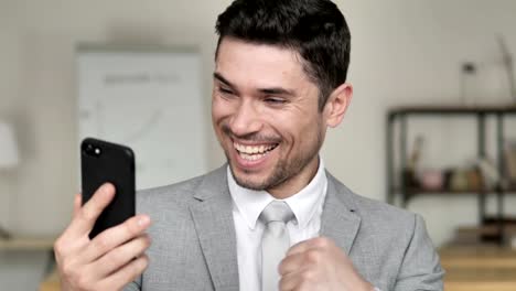 Businessman-Excited-for-Success-on-Smartphone