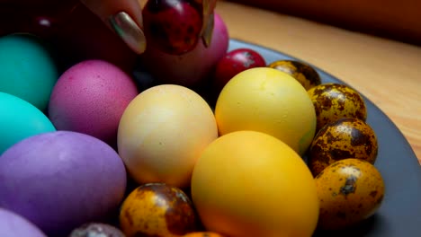 Woman's-hand-laid-red-and-green-colored-quail-egg