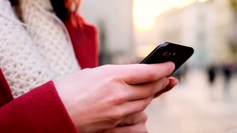 Attractive-young-woman-texting-on-the-street