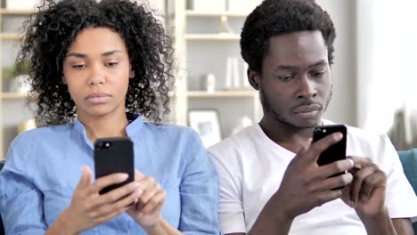 African-Man-and-Woman-Using-Smartphone