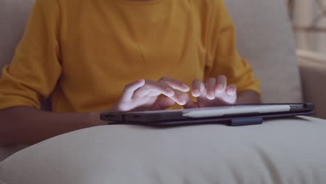 Hand-touching-keyboard-on-modern-digital-tablet