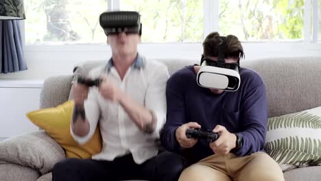 Gay-couple-relaxing-on-couch-playing-virtual-reality-games.-Exciting-mood.-Bouncing-around.