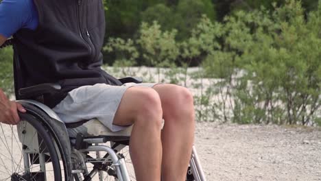 Slowmotion-closeup-of-disabled-young-student-man-in-a-wheelchair