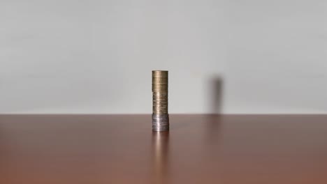 Coins-in-stop-motion-increase-upwards-on-a-piece-of-furniture