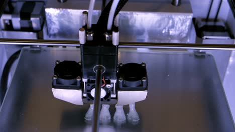 Three-dimensional-printer-during-work-in-laboratory,-3D-plastic-printer,-3D-printing