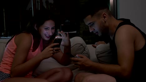 Insomnia-concept-and-smartphone-addiction-with-sleepy-married-couple-with-communication-problems-chatting-on-their-smartphone-and-ignoring-each-other-late-at-night