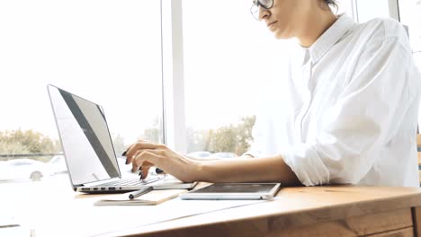 Woman-using-laptop-and-tablet