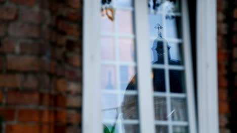 Church-reflected-in-window-of-private-residence,-devotion-to-religion,-Christian