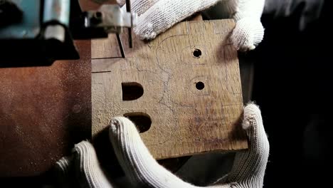 cutting-jigsaw-in-a-wooden-workpiece,-the-symbol-of-bitcoin