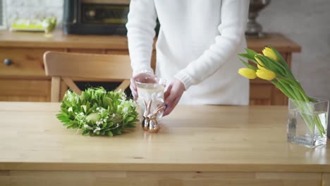 woman-arranges-beautiful-Easter-decorations-on-the-table