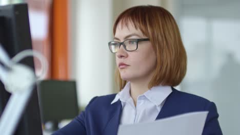 Concentrated-Businesswoman-in-Wheelchair-Reading-Documents