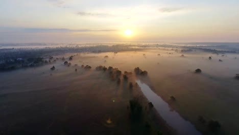 Aerial-footage-video-of-foggy-morning.-Flying-over-the-Desna-river.-Sunrise-time.-Kyiv-region,-Ukraine.