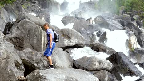 The-traveler-scrambles-along-the-cascading-waterfall.