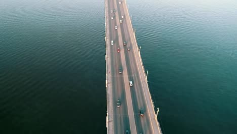 Aerial-top-view-of-bridge-road-automobile-traffic-of-many-cars,-transportation-concept