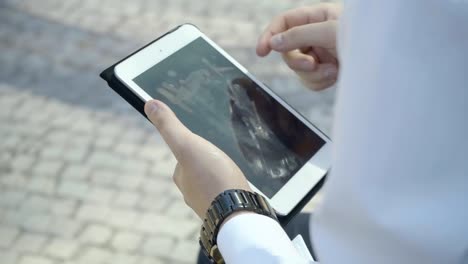 Extreme-close-up-shot-of-male-hands-working-on-white-tablet