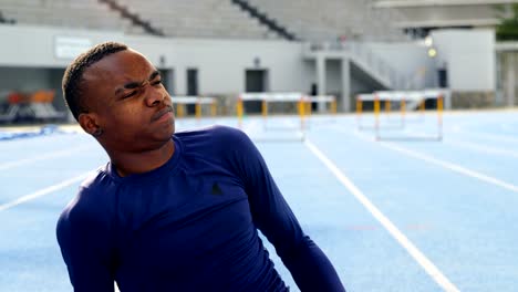 Disabled-athletic-frowning-in-pain-on-running-track