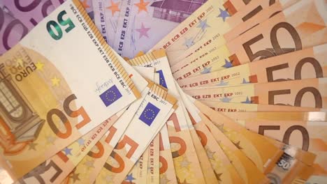 VIDEO,-extremely-close-up-of-euro-banknotes,-rotational-slow-motion