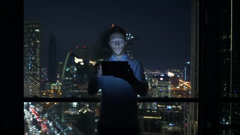 Caucasian-man-using-digital-tablet-for-internet-and-communications-with-cityscape-background