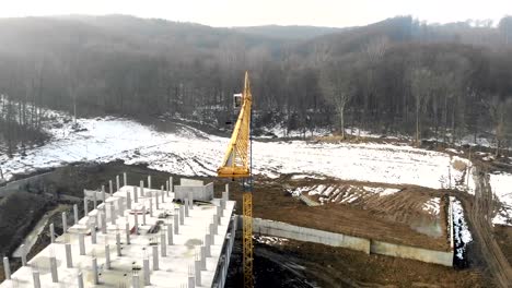 Construction-in-winter.-Flying-near-high-rise-construction-crane.