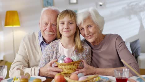 Portrait-of-Grandparents-and-Granddaughter-Celebrating-Easter